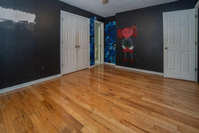 unfurnished bedroom featuring baseboards and wood finished floors