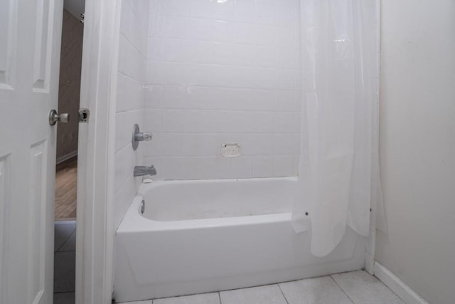 bathroom featuring tile patterned floors, shower / bath combination with curtain, and baseboards