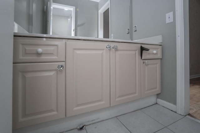 bathroom with baseboards and tile patterned flooring