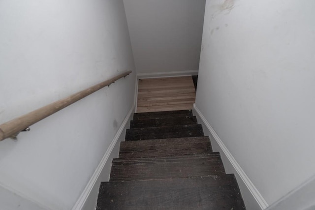 stairway with wood finished floors