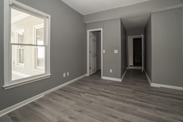 empty room with wood finished floors and baseboards