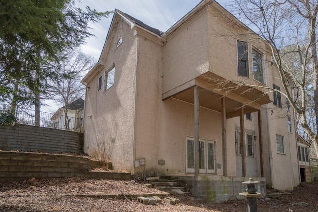 rear view of property with stucco siding