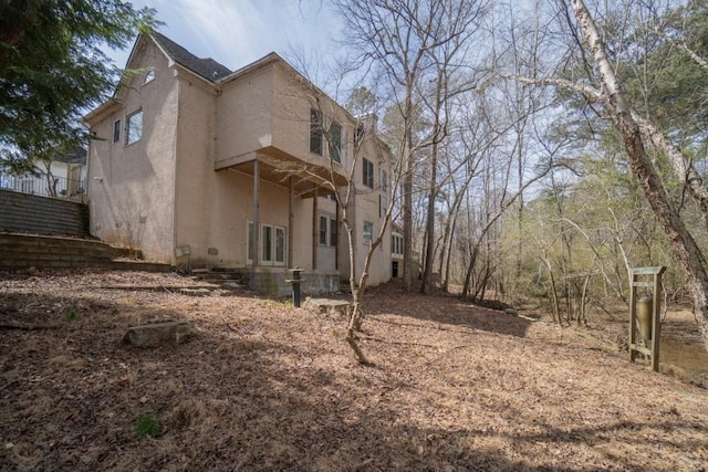 view of property exterior with stucco siding and french doors