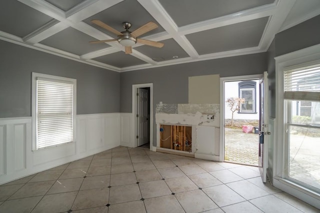 unfurnished room with light tile patterned floors, wainscoting, coffered ceiling, and ceiling fan