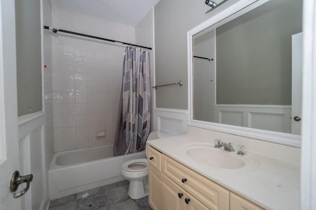 full bath featuring shower / bathtub combination with curtain, vanity, wainscoting, and toilet