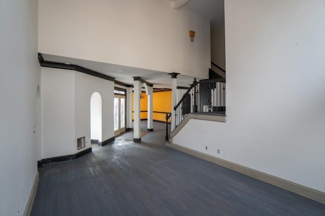 unfurnished living room featuring visible vents, stairway, wood finished floors, and baseboards