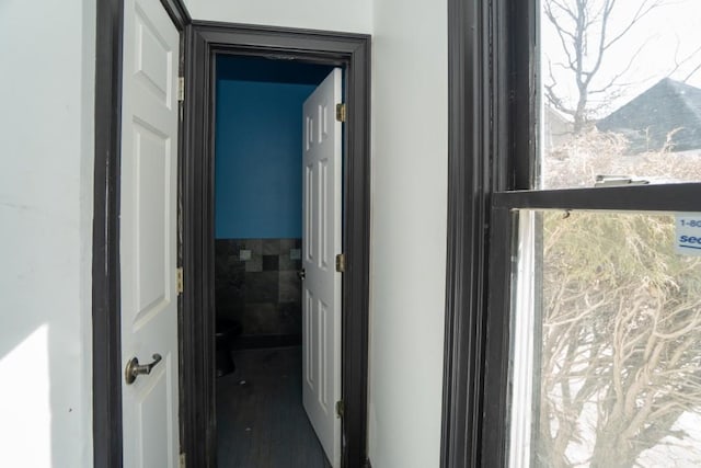 hallway with tile walls