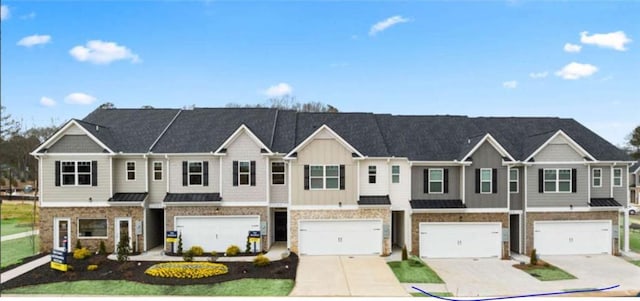 339 Elgin Dr, Lawrenceville, GA 30045 - view of property with stone siding, driveway, board and batten siding, and a garage