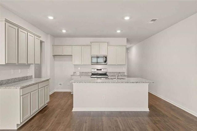 339 Elgin Dr, Lawrenceville, GA 30045 - kitchen featuring stainless steel appliances, a center island with sink, baseboards, dark wood-style floors, and recessed lighting