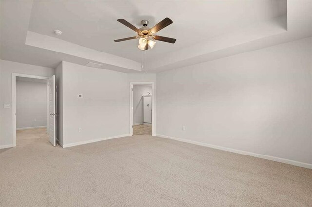 339 Elgin Dr, Lawrenceville, GA 30045 - empty room featuring baseboards, a ceiling fan, a tray ceiling, and light colored carpet