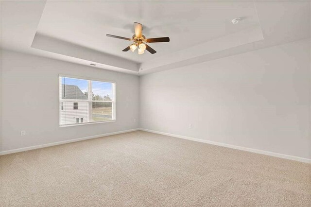 339 Elgin Dr, Lawrenceville, GA 30045 - carpeted empty room with a tray ceiling, a ceiling fan, and baseboards