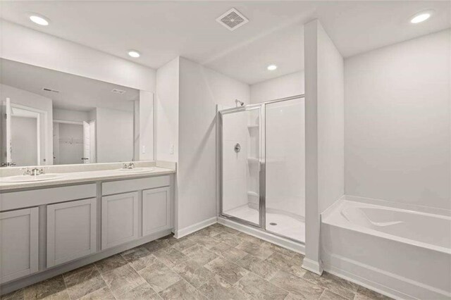 339 Elgin Dr, Lawrenceville, GA 30045 - full bath featuring a sink, double vanity, baseboards, visible vents, and a shower stall