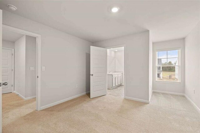 339 Elgin Dr, Lawrenceville, GA 30045 - unfurnished bedroom with light colored carpet, baseboards, ensuite bath, and recessed lighting