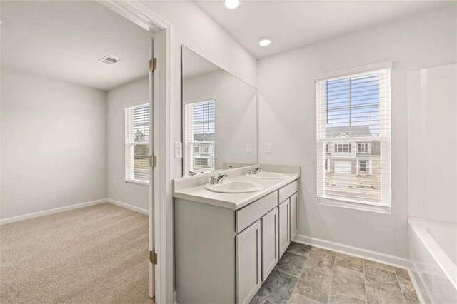 339 Elgin Dr, Lawrenceville, GA 30045 - full bath with double vanity, visible vents, baseboards, and a sink