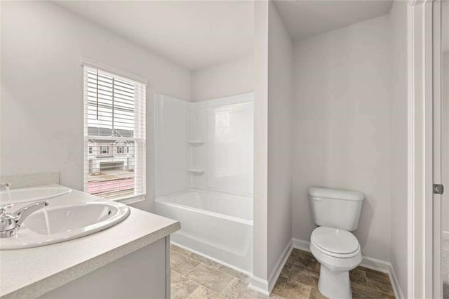 339 Elgin Dr, Lawrenceville, GA 30045 - bathroom featuring a sink, double vanity, toilet, baseboards, and stone finish flooring