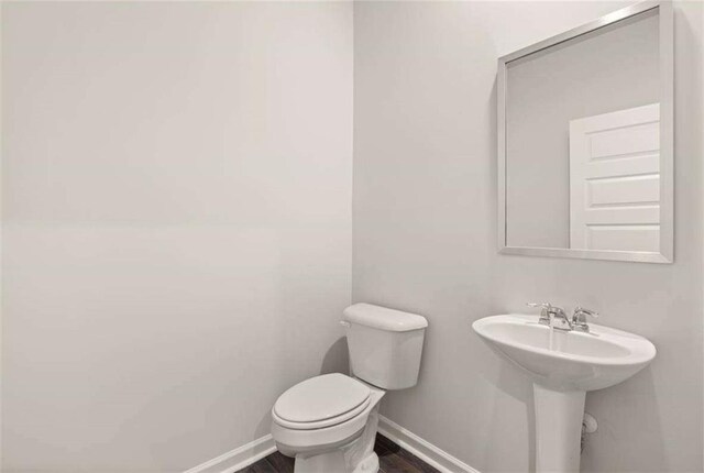 339 Elgin Dr, Lawrenceville, GA 30045 - bathroom featuring wood finished floors, baseboards, a sink, and toilet