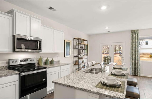 339 Elgin Dr, Lawrenceville, GA 30045 - kitchen featuring dark wood-style flooring, stainless steel appliances, and plenty of natural light