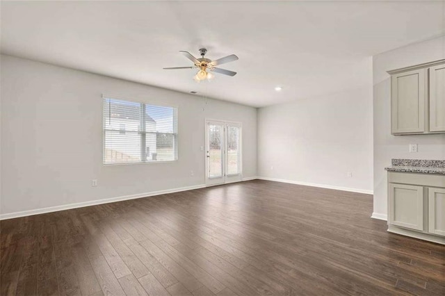 339 Elgin Dr, Lawrenceville, GA 30045 - unfurnished living room featuring baseboards, dark wood-type flooring, and ceiling fan