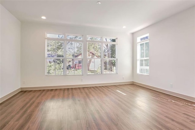 spare room with hardwood / wood-style floors