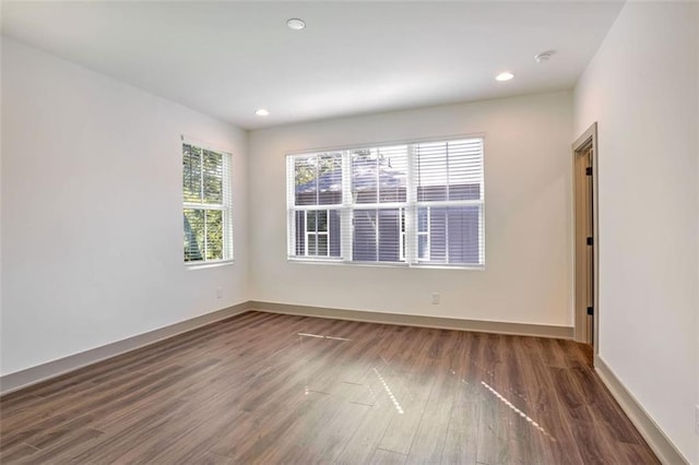 empty room with dark wood-type flooring