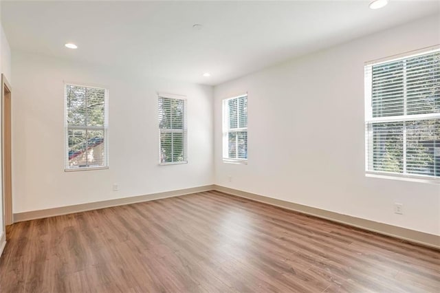 empty room with light hardwood / wood-style flooring