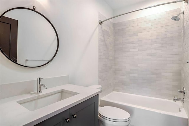 full bathroom featuring toilet, vanity, and tiled shower / bath combo