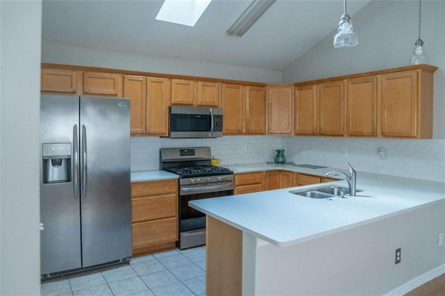 kitchen with sink, appliances with stainless steel finishes, hanging light fixtures, light tile patterned flooring, and kitchen peninsula