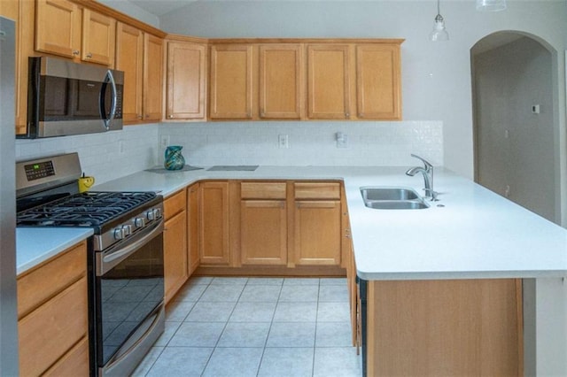 kitchen featuring light tile patterned flooring, sink, decorative backsplash, hanging light fixtures, and stainless steel appliances