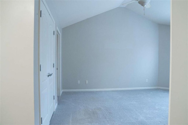 interior space with lofted ceiling, carpet flooring, and ceiling fan