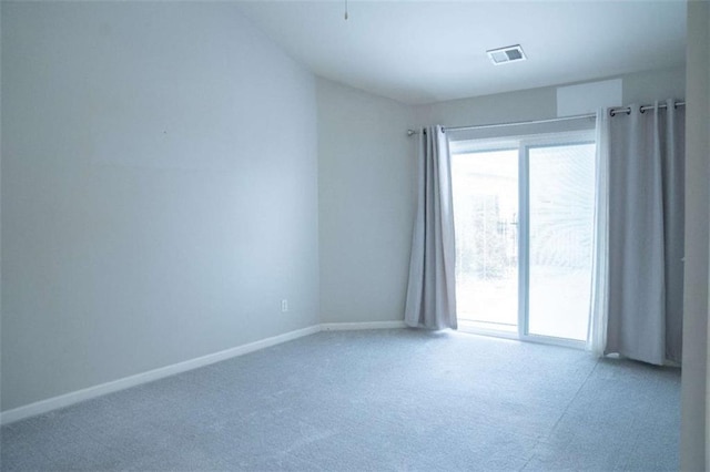 spare room featuring plenty of natural light and carpet floors