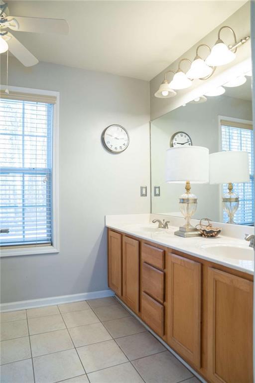 bathroom with ceiling fan, vanity, and tile patterned flooring