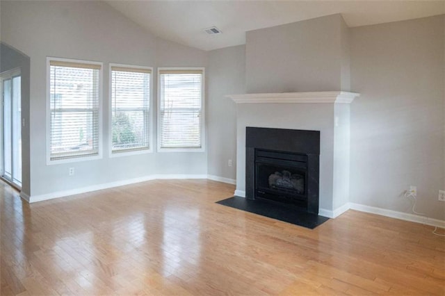 unfurnished living room with light hardwood / wood-style flooring and vaulted ceiling