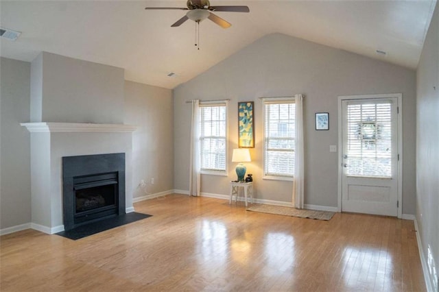 unfurnished living room featuring vaulted ceiling, ceiling fan, and light wood-type flooring