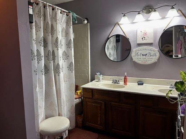 bathroom with vanity and shower / bath combo with shower curtain