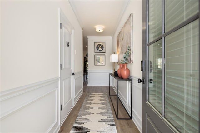 entryway featuring wood-type flooring and ornamental molding