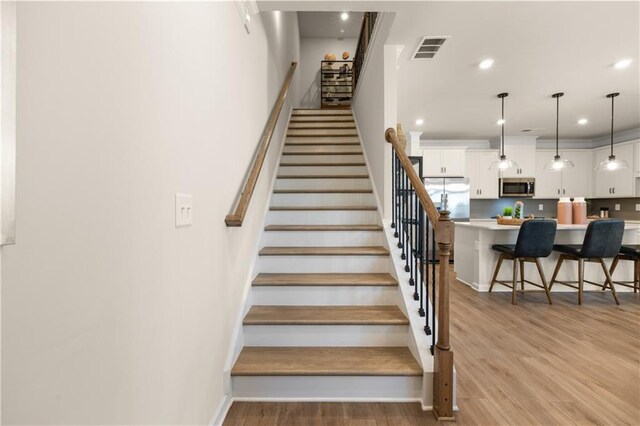 staircase featuring hardwood / wood-style flooring