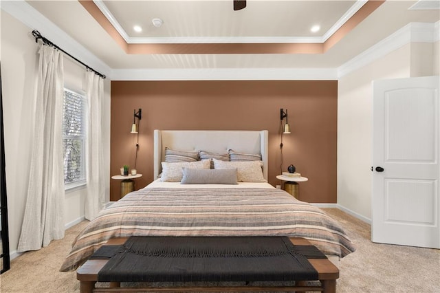 carpeted bedroom featuring ceiling fan, ornamental molding, and a raised ceiling