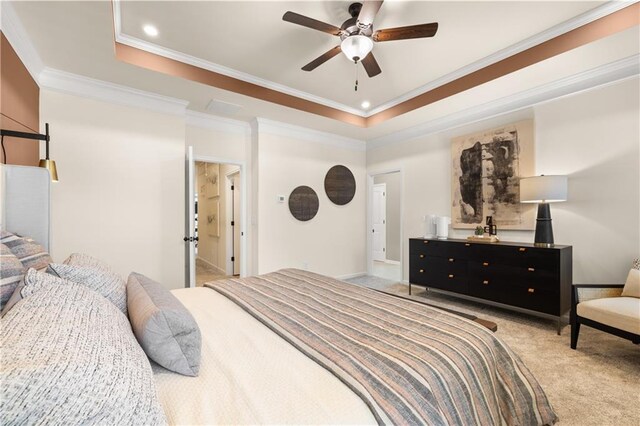 bedroom with ornamental molding, light colored carpet, ceiling fan, and a raised ceiling