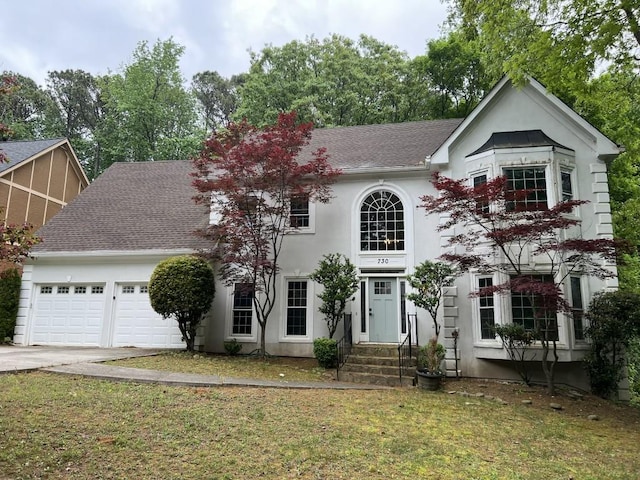 730 Redlion Run, Alpharetta, GA 30022 - view of front facade featuring a garage, driveway, stucco siding, a front yard, and roof with shingles