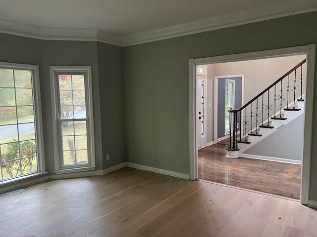 730 Redlion Run, Alpharetta, GA 30022 - unfurnished room with healthy amount of natural light, stairway, hardwood / wood-style floors, and ornamental molding