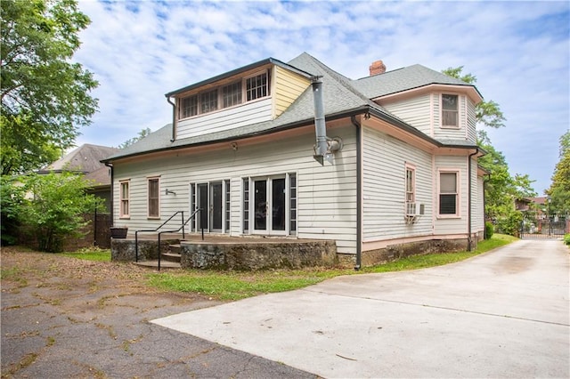 back of house featuring cooling unit