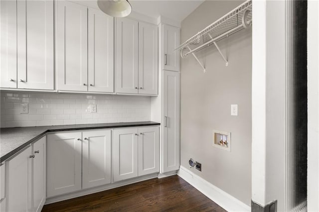 clothes washing area with cabinet space, hookup for a washing machine, baseboards, and dark wood finished floors