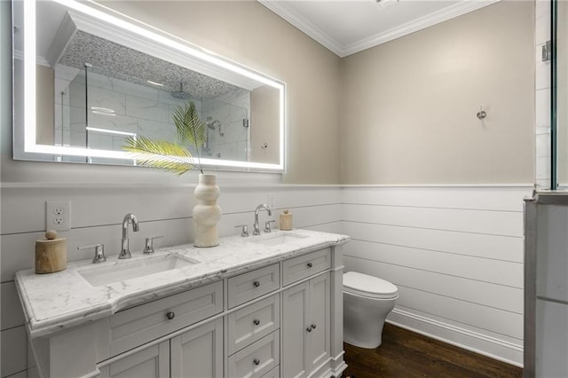 full bath featuring a sink, crown molding, wood finished floors, and a tile shower