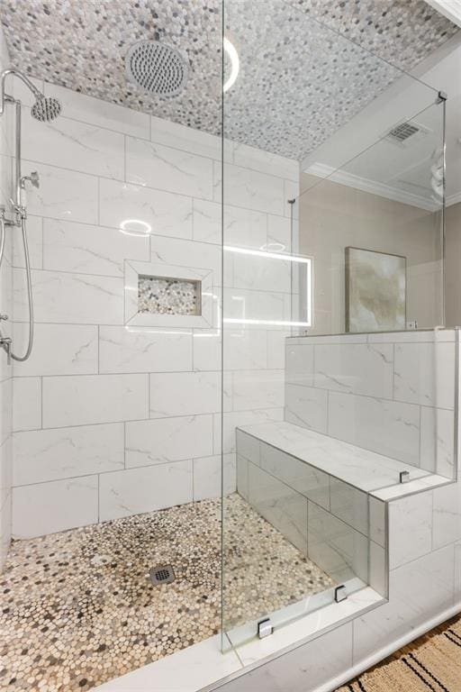 bathroom featuring visible vents and tiled shower