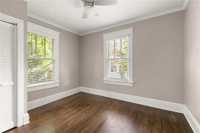 unfurnished room with ceiling fan, ornamental molding, baseboards, and dark wood-type flooring