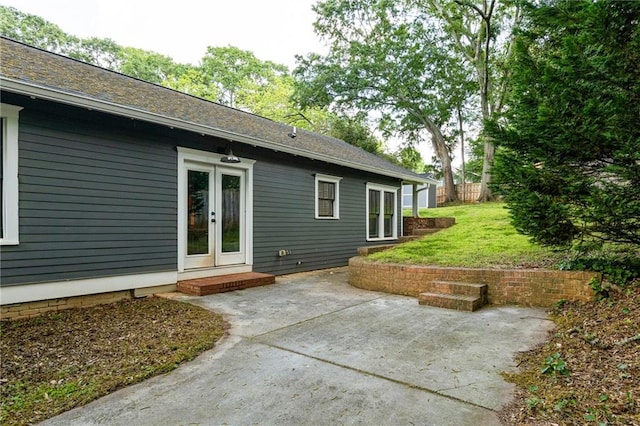 rear view of property with a yard, a patio area, and french doors