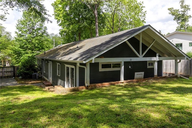 view of outbuilding featuring central AC and fence