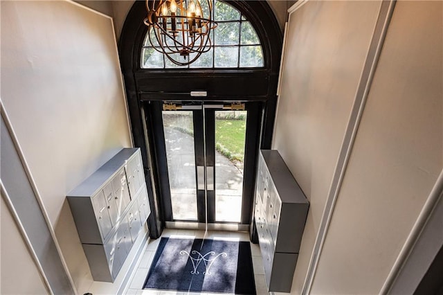 foyer entrance with plenty of natural light, a mail area, and tile patterned flooring