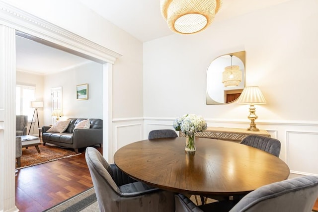 dining area featuring hardwood / wood-style flooring and crown molding