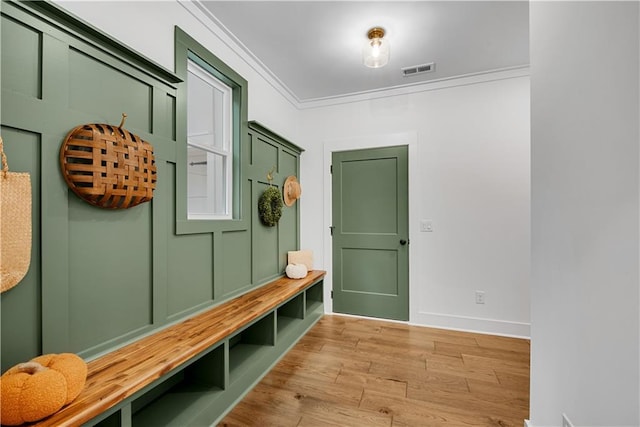 mudroom featuring light hardwood / wood-style flooring and crown molding